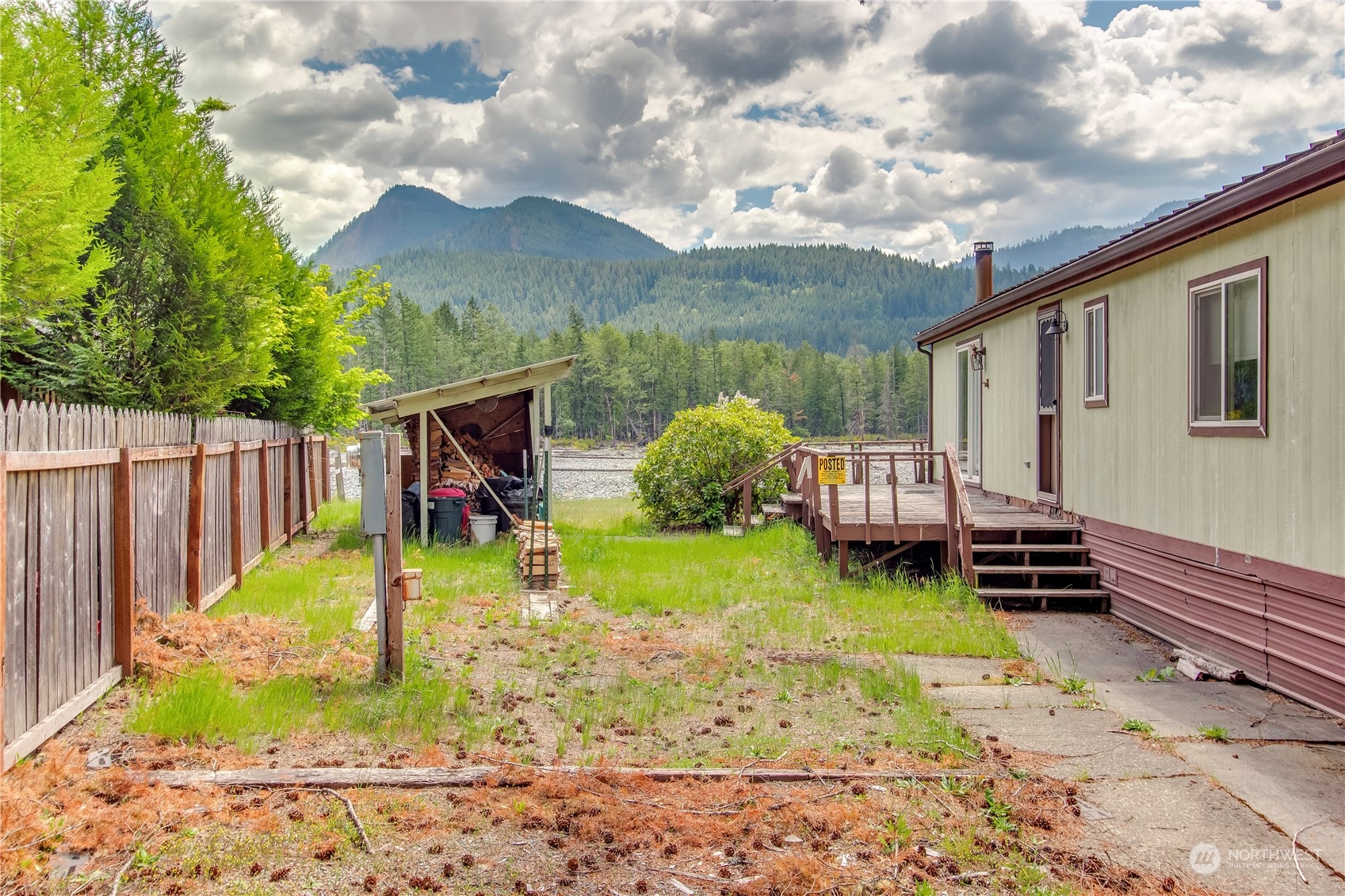 140 Maple Place Packwood, WA 98361 - Photo 2 of 39 a view of a backyard with plants and a patio