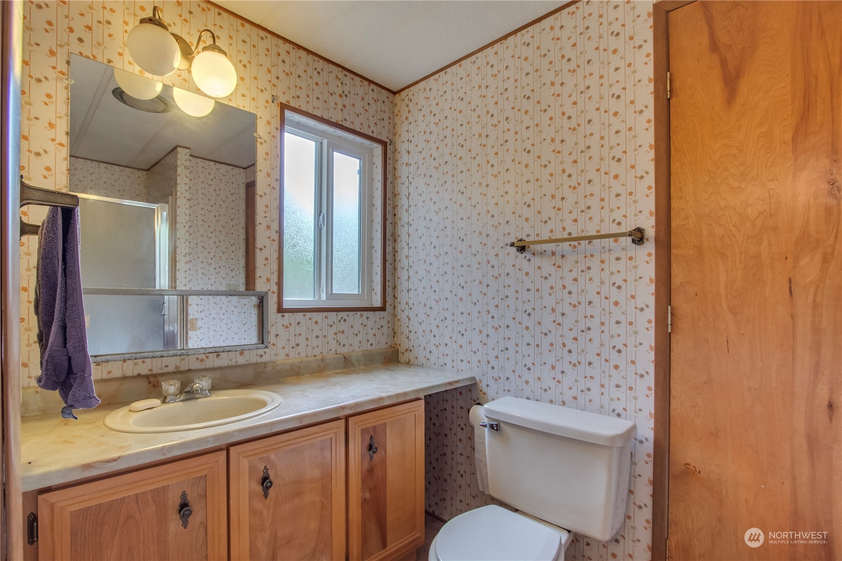140 Maple Place Packwood, WA 98361 - Photo 24 of 39 a bathroom with a granite countertop toilet a sink and mirror
