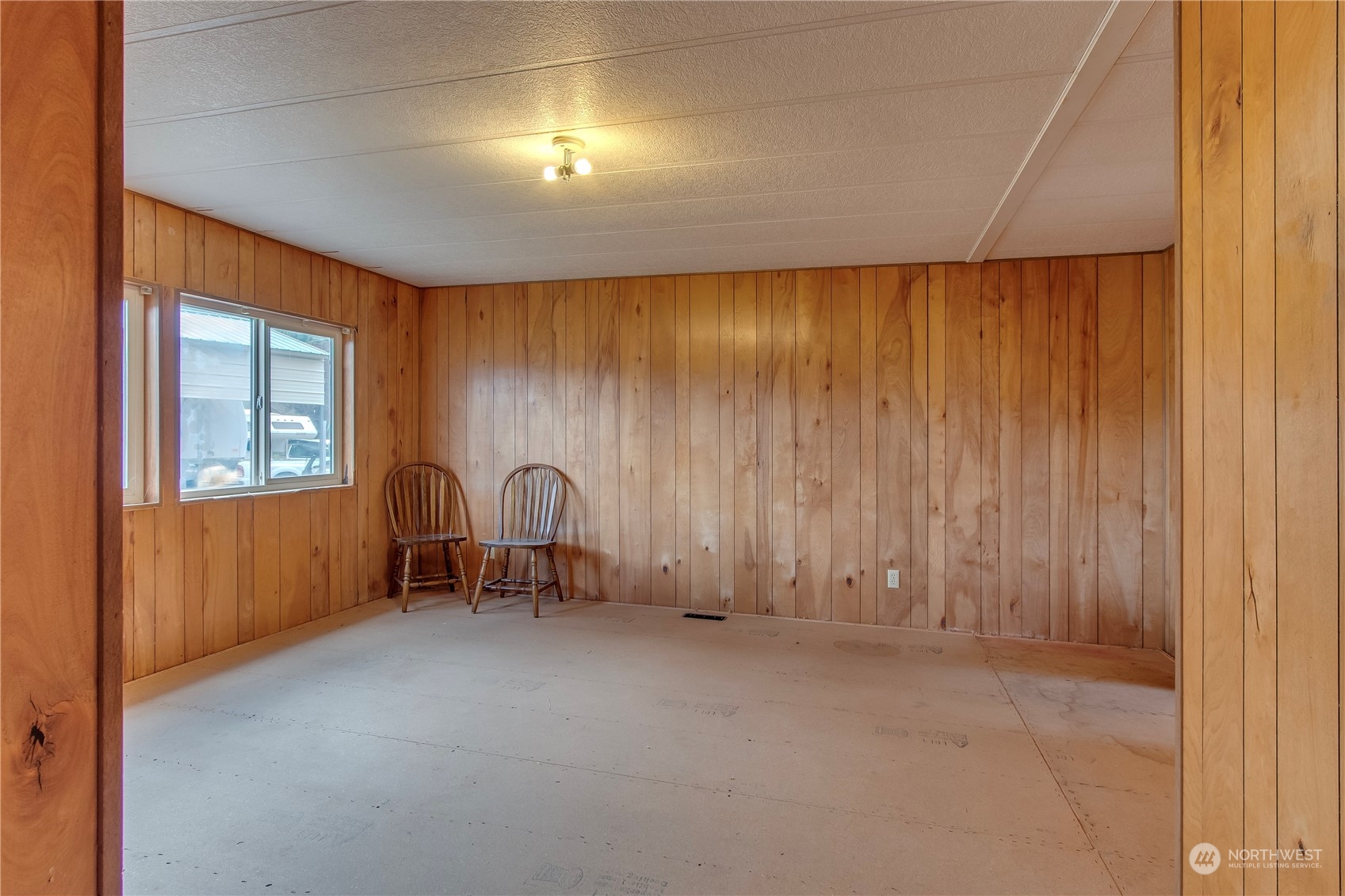 140 Maple Place Packwood, WA 98361 - Photo 28 of 39 an empty room with chandelier fan and couches