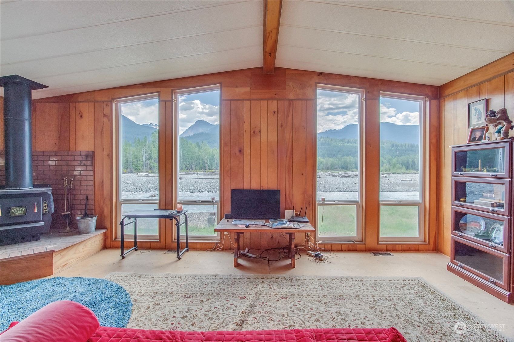 140 Maple Place Packwood, WA 98361 - Photo 34 of 39 a living room filled with furniture and a floor to ceiling window