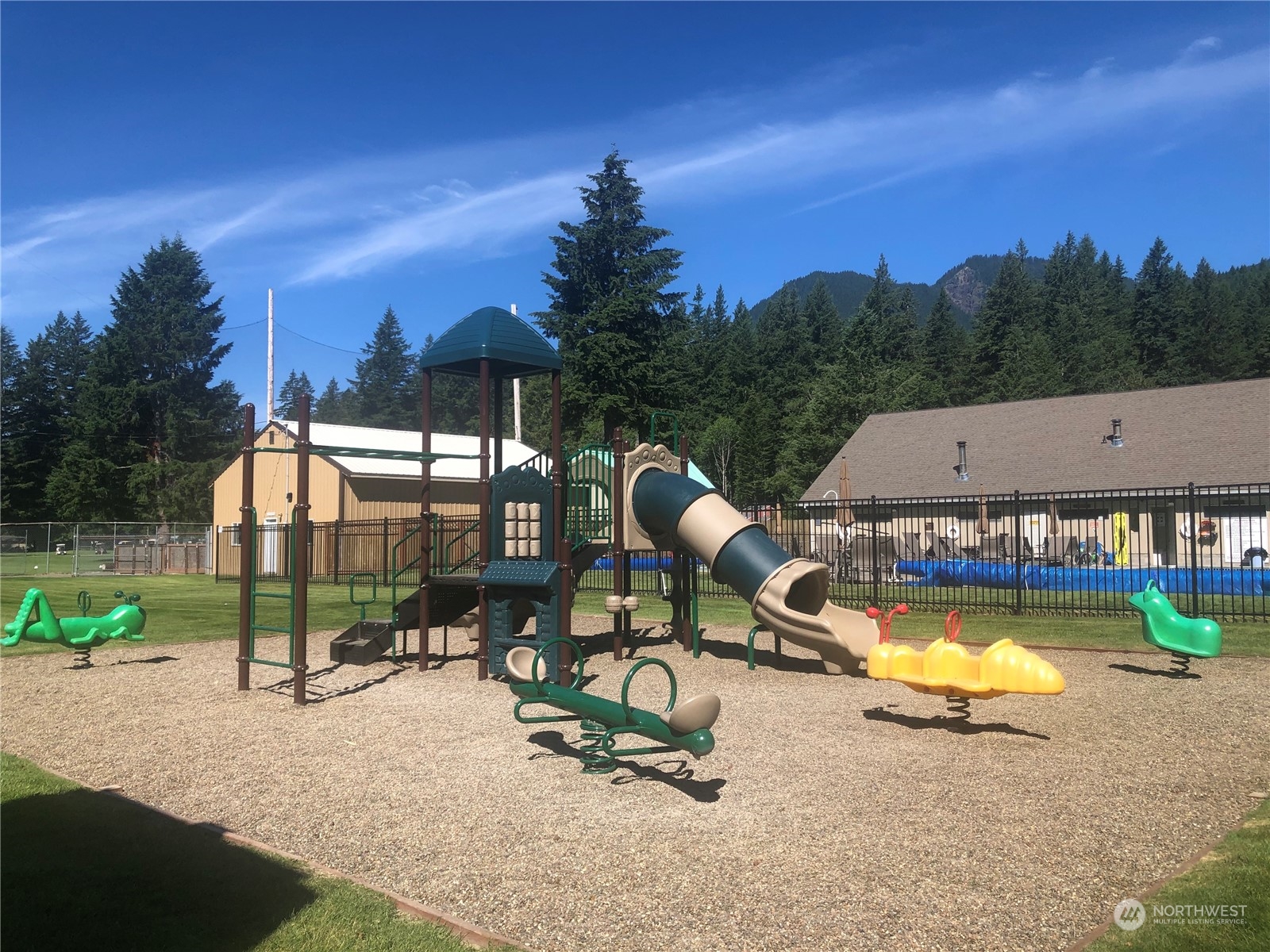 140 Maple Place Packwood, WA 98361 - Photo 38 of 39 a view of a swimming pool with a patio and a garden