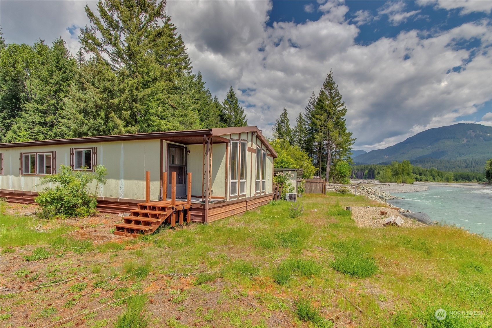 140 Maple Place Packwood, WA 98361 - Photo 8 of 39 a backyard of a house with barbeque oven table and chairs
