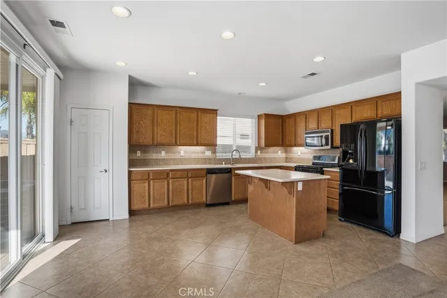 a view of a kitchen with a sink stainless steel appliances and cabinets