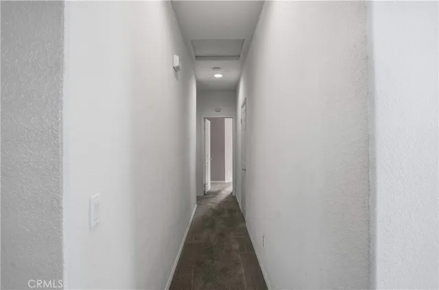 a view of an empty room with a ceiling fan