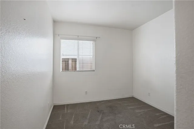 an empty room with sliding door and mirror