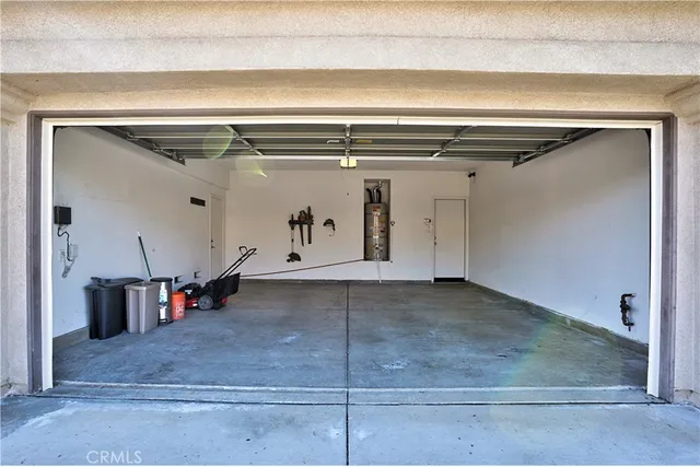 a view of a pathway of a house with backyard and wooden fence