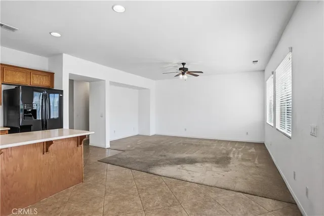 a kitchen with stainless steel appliances granite countertop a refrigerator and a stove top oven