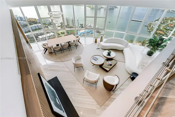 a view of a dining room with furniture and a floor to ceiling window