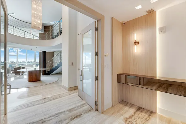 a view of a hallway with wooden floor and living room