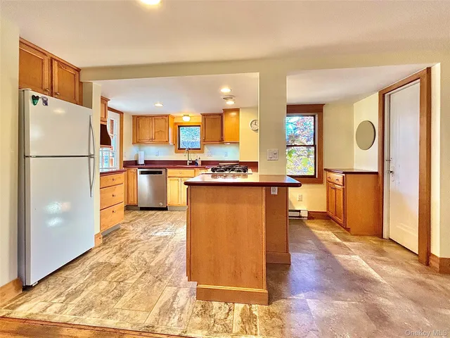 a kitchen with a stove a sink and a refrigerator