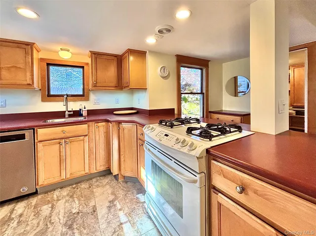 a kitchen with a stove a sink and a cabinets