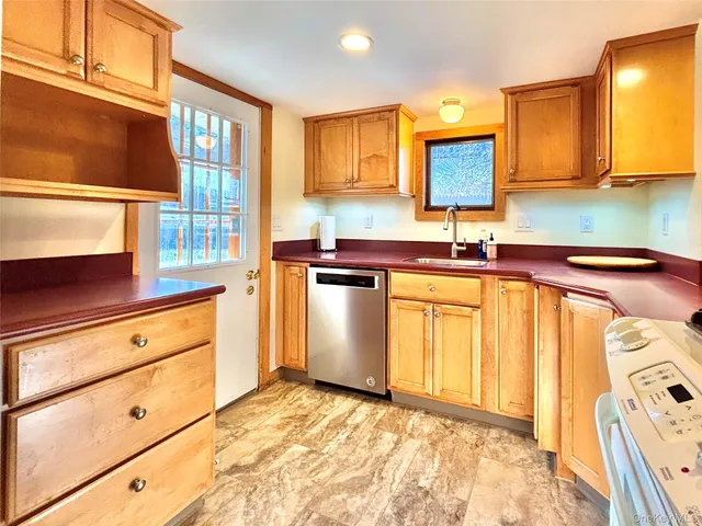 a large kitchen with stainless steel appliances granite countertop a refrigerator and a stove top oven