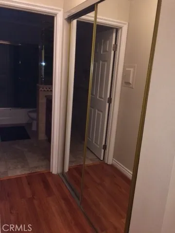 an entryway door with wooden floor