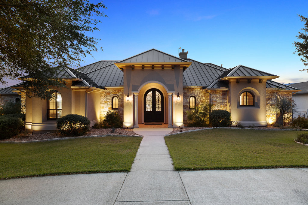 a front view of a house with a garden