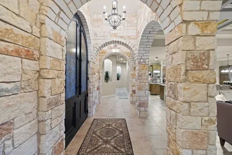 a view of a hallway with chandelier