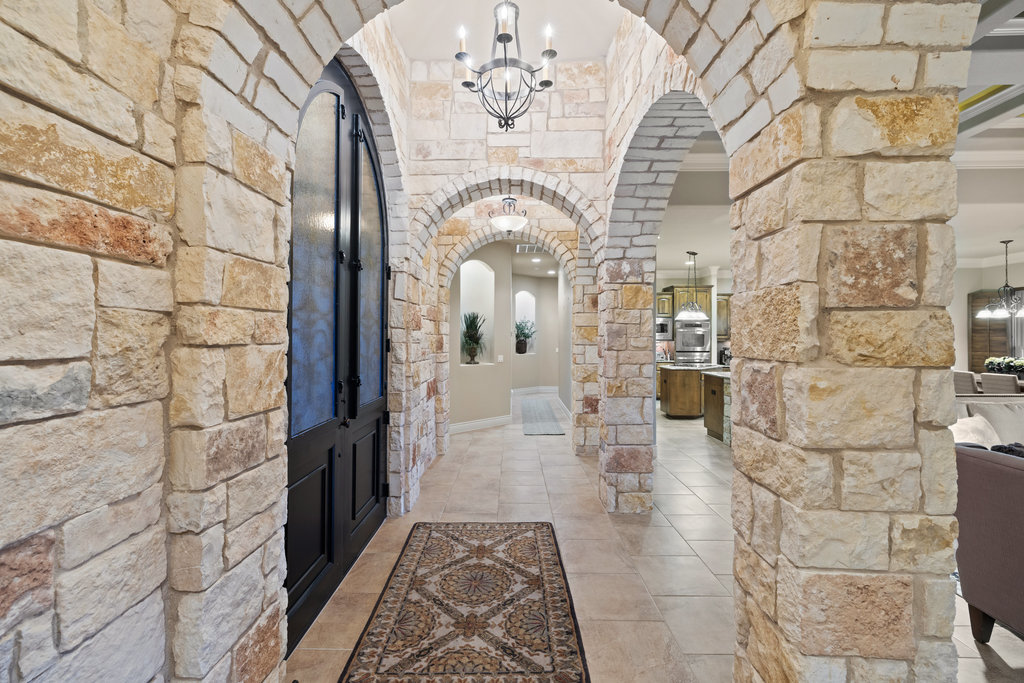 839 Wesley Ridge Drive Spicewood, TX 78669 - Photo 15 of 40 a view of a hallway with chandelier