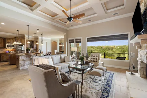 a living room with furniture and a floor to ceiling window