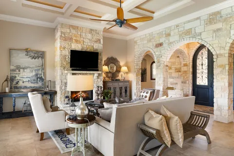 a living room with furniture a flat screen tv and a fireplace