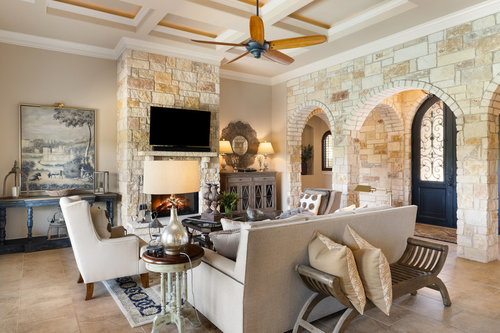 839 Wesley Ridge Drive Spicewood, TX 78669 - Photo 17 of 40 a living room with furniture a flat screen tv and a fireplace
