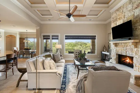 a living room with furniture a flat screen tv and a fireplace