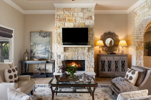 a living room with furniture a flat screen tv and a fireplace