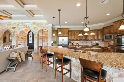 a large kitchen with a table and chairs