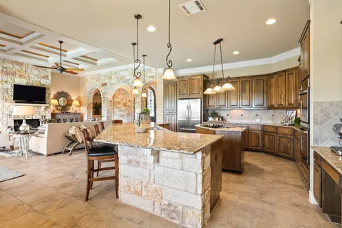 a large kitchen with lots of counter space and windows