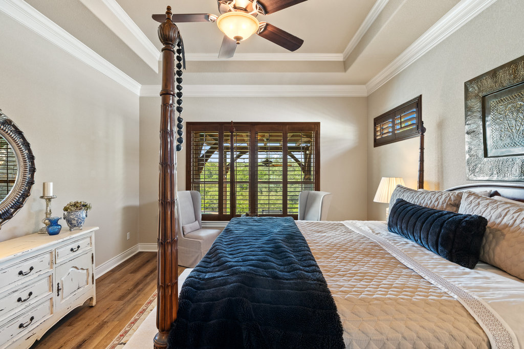 839 Wesley Ridge Drive Spicewood, TX 78669 - Photo 28 of 40 a bedroom with a large bed and a window