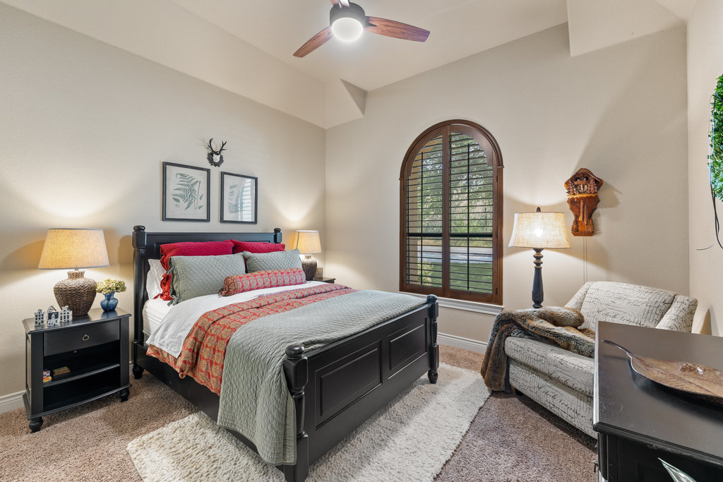 839 Wesley Ridge Drive Spicewood, TX 78669 - Photo 33 of 40 a bedroom with a bed and a large window