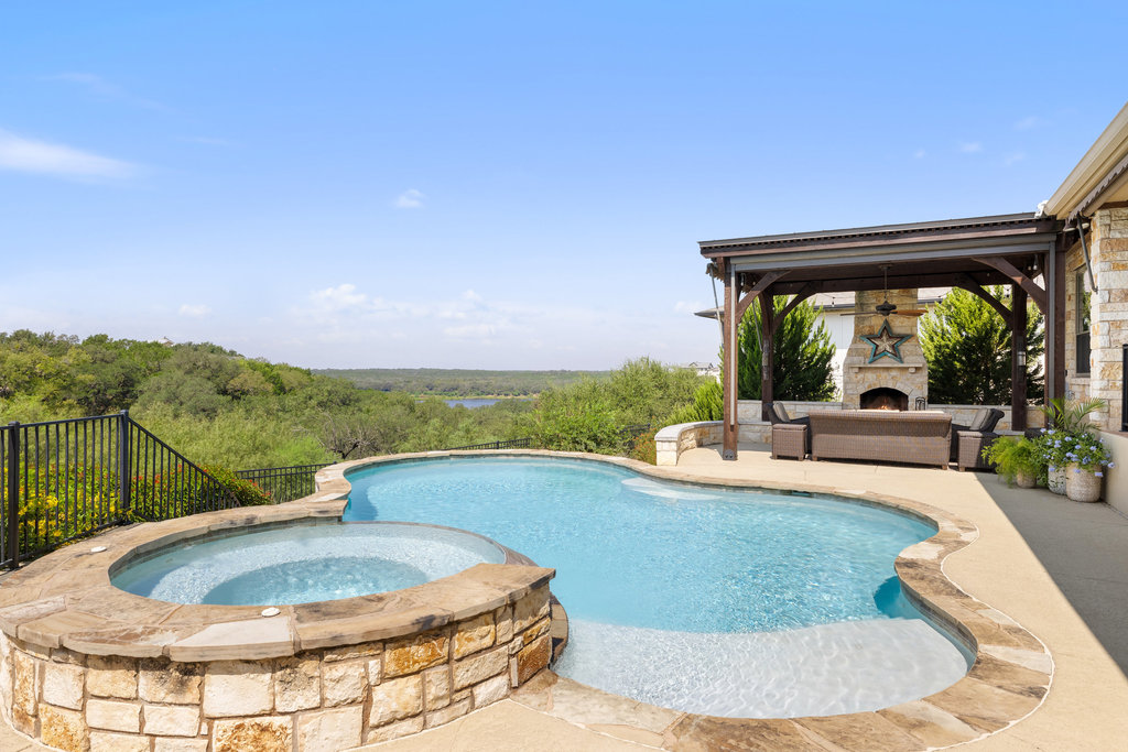 839 Wesley Ridge Drive Spicewood, TX 78669 - Photo 35 of 40 a view of a swimming pool with a patio