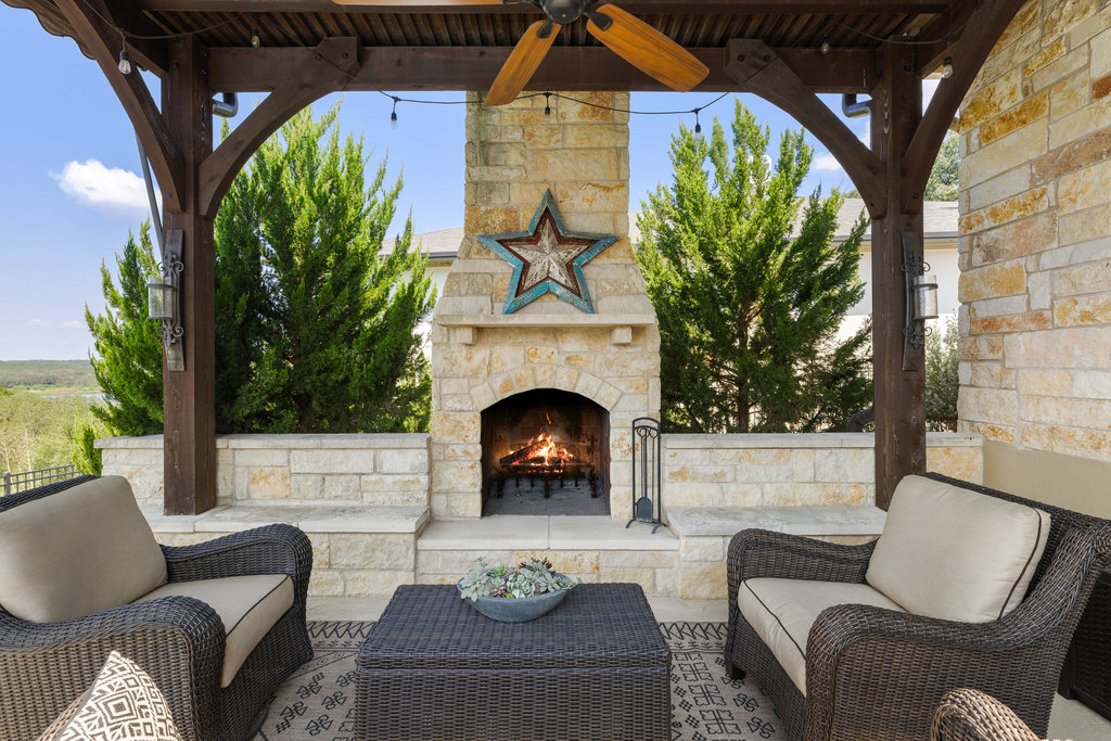 839 Wesley Ridge Drive Spicewood, TX 78669 - Photo 36 of 40 a living room with furniture and a fireplace