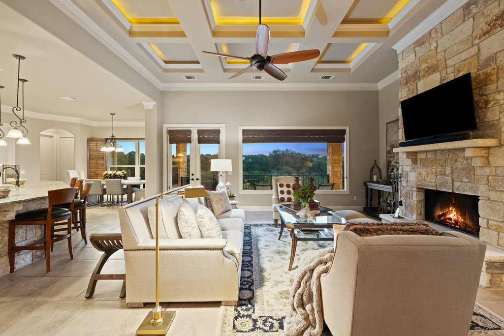 839 Wesley Ridge Drive Spicewood, TX 78669 - Photo 5 of 40 a living room with furniture a flat screen tv and a fireplace