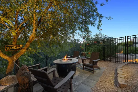 a backyard of a house with fire pit barbeque oven and outdoor seating