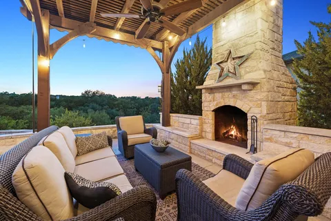 a outdoor living space with patio furniture and a fireplace
