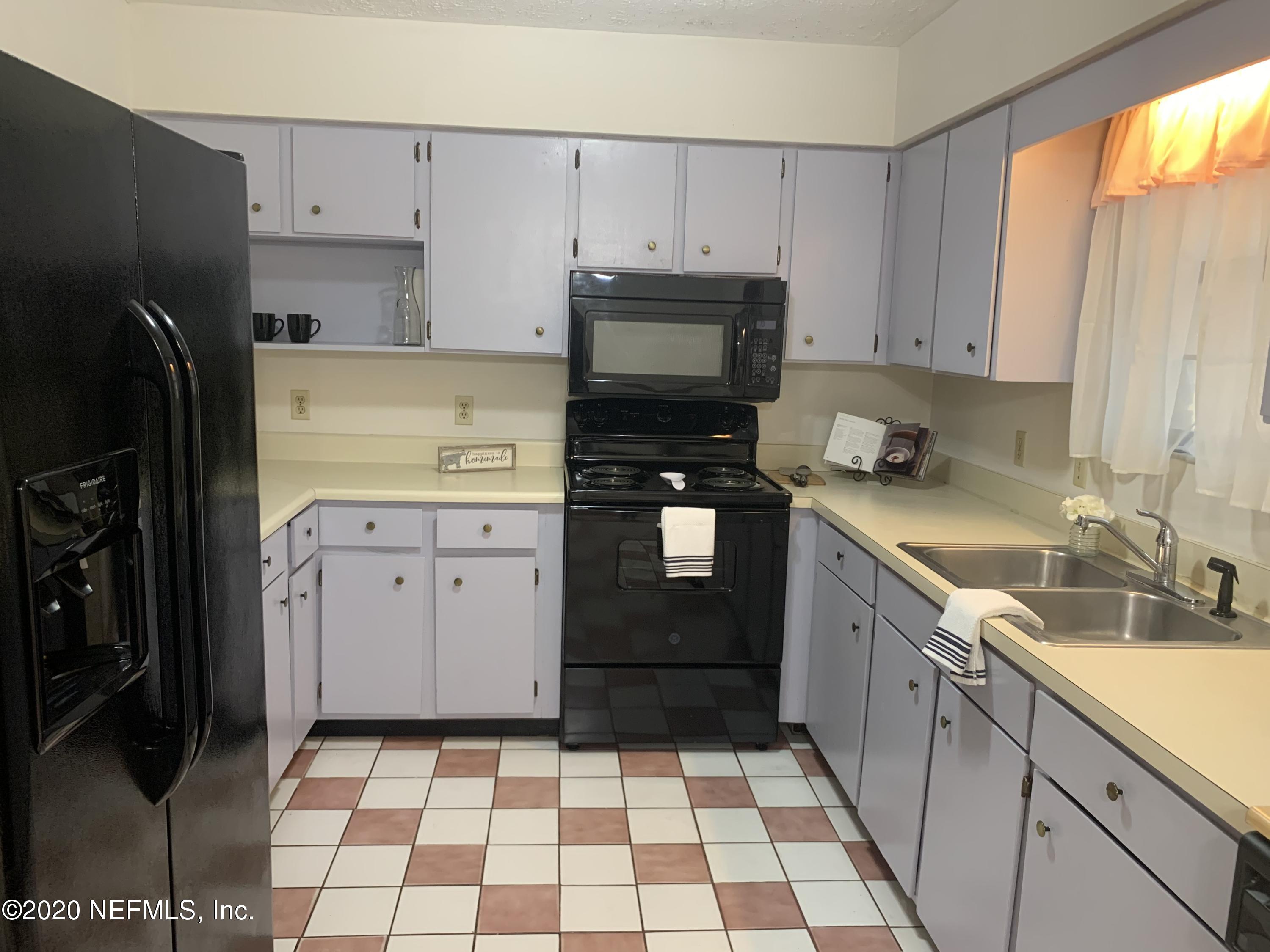 420 Southwest Naha Street Keystone Heights, FL 32656 - Photo 13 of 29 a kitchen with a sink a stove and refrigerator