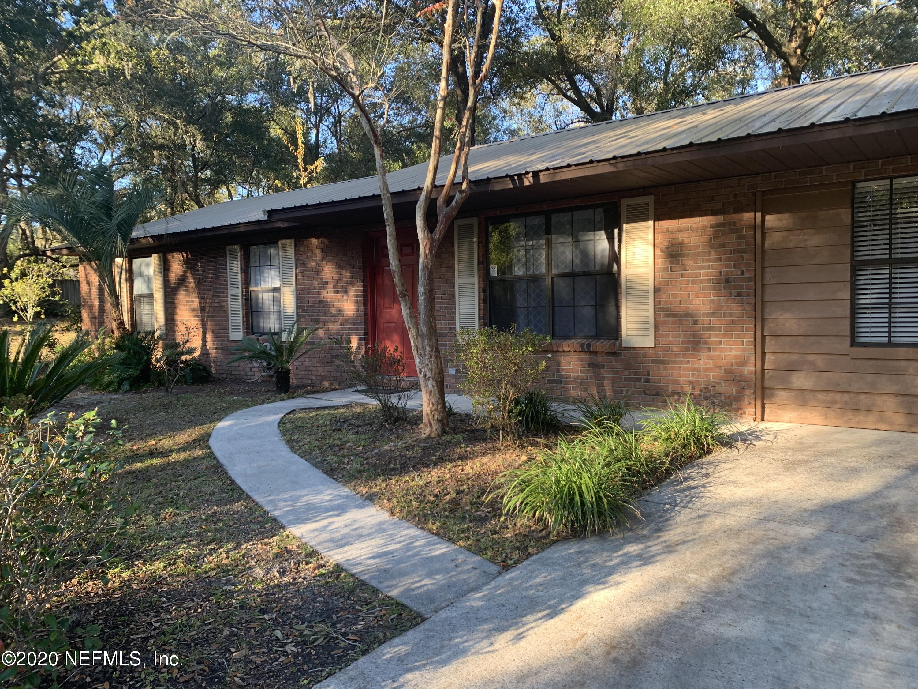 420 Southwest Naha Street Keystone Heights, FL 32656 - Photo 2 of 29 a front view of a house with a yard and potted plants