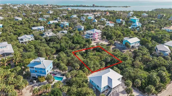 an aerial view of residential houses with outdoor space and street view