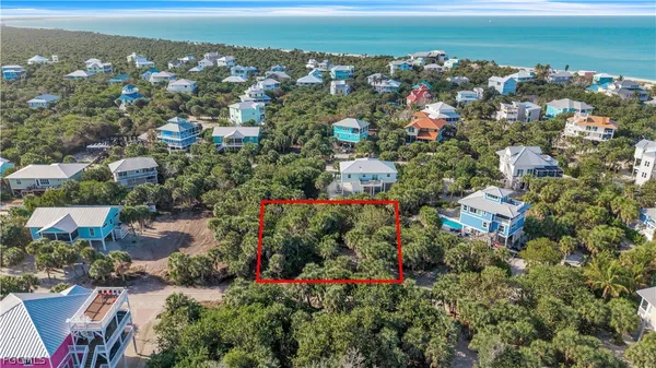 an aerial view of a houses with a yard