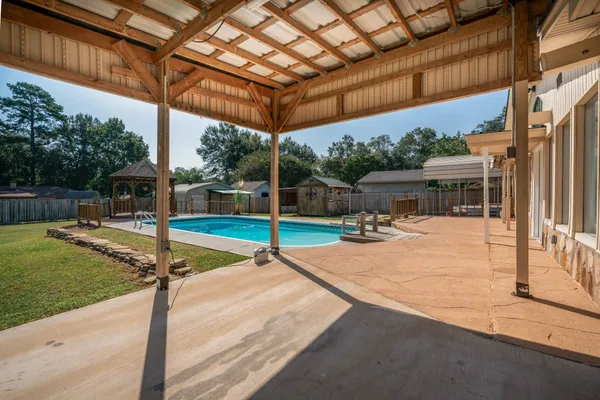 a view of a patio with a table and chairs