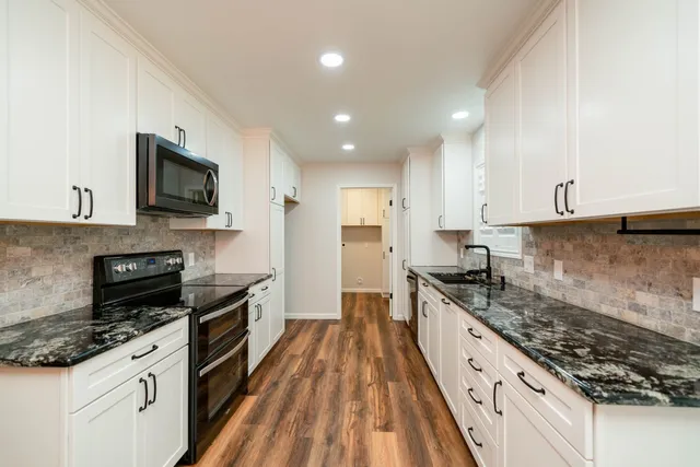 a large kitchen with a stove and a sink