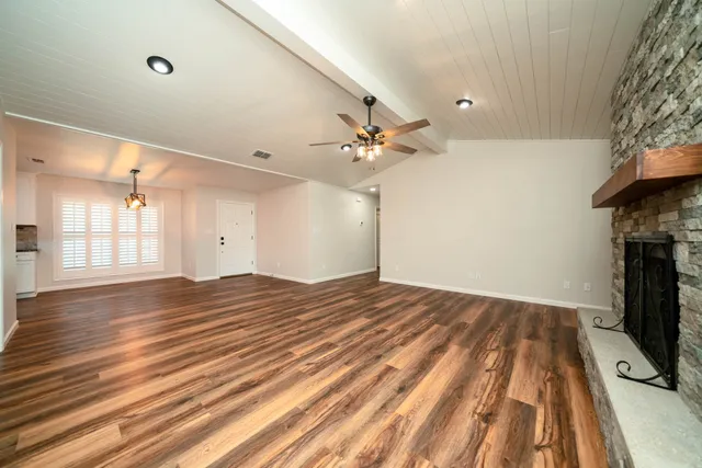 wooden floor in an empty room with a fireplace