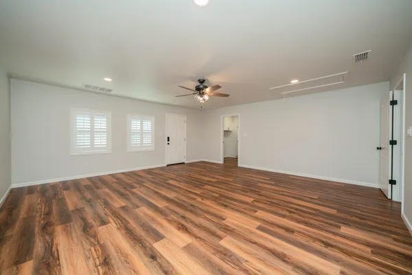a view of a livingroom with a ceiling fan and window