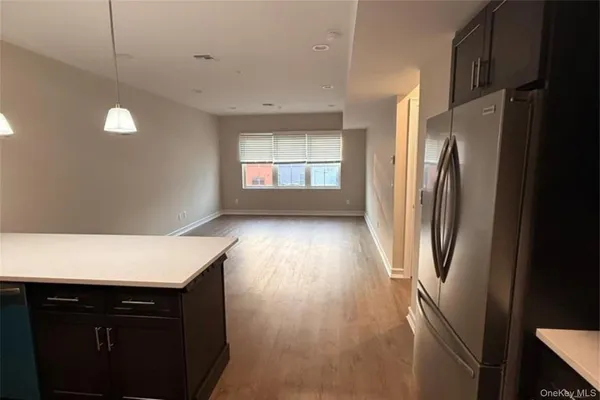 a kitchen with stainless steel appliances a refrigerator and a window