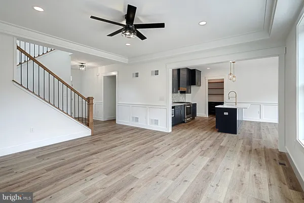 a view of hallway with wooden floor and stairs