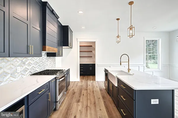a kitchen with a sink stove and cabinets