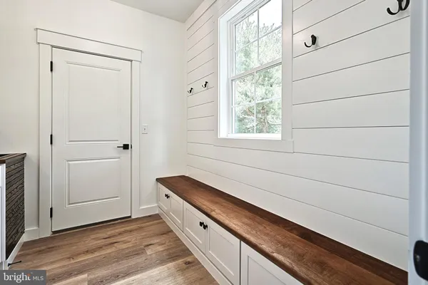 a view of a kitchen cabinets a sink and wooden floor