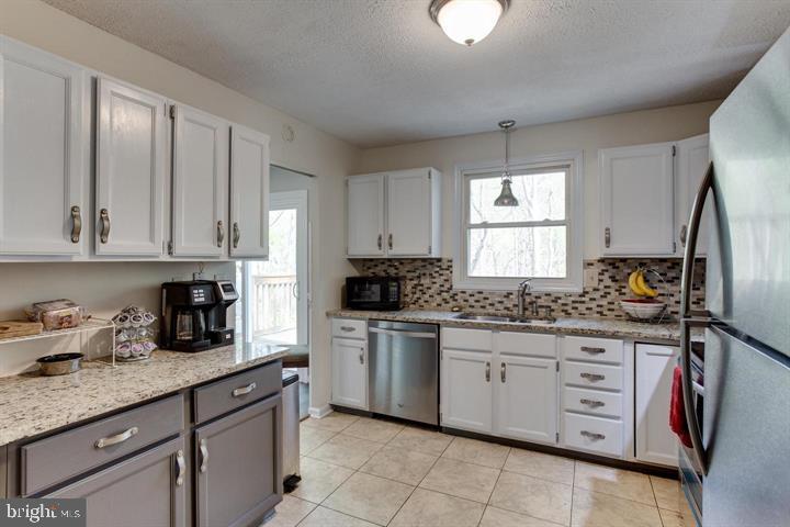 37352 Asher Road Mechanicsville, MD 20659 - Photo 6 of 11 a kitchen with stainless steel appliances granite countertop a sink and cabinets