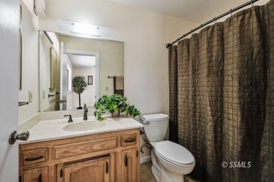 418 North Inyo Street Ridgecrest, CA 93555 - Photo 20 of 35 a bathroom with a granite countertop toilet sink and mirror