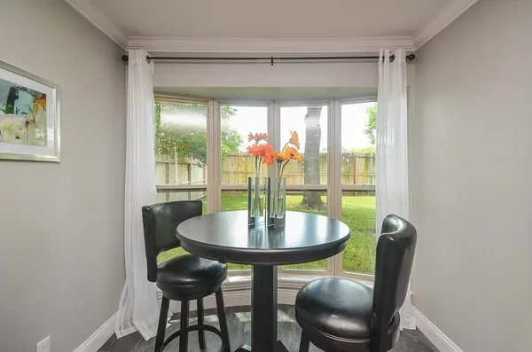a dining room with furniture and window