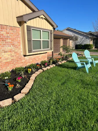 a front view of a house with a garden and plants